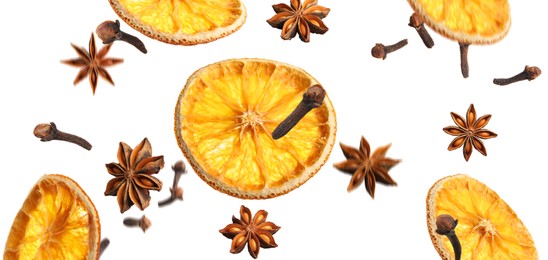 Image of Slices of dried orange, aromatic anise stars and cloves falling on white background. Banner design