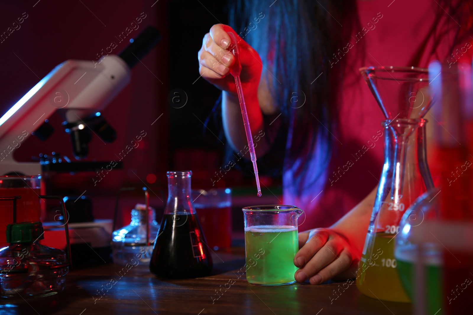 Photo of Child doing chemical research in laboratory, closeup. Dangerous experiment