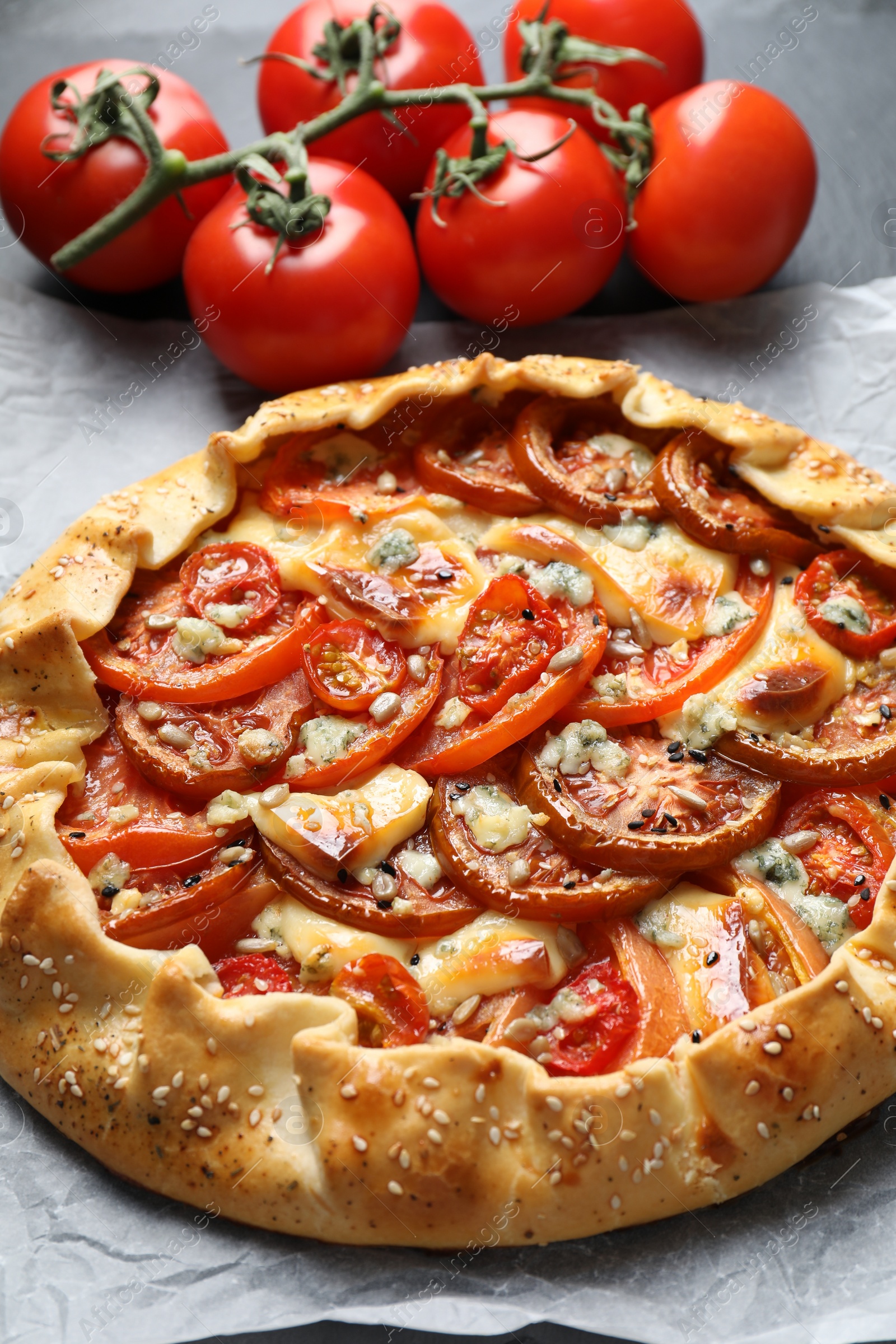 Photo of Tasty galette with tomato and cheese (Caprese galette) on table, closeup