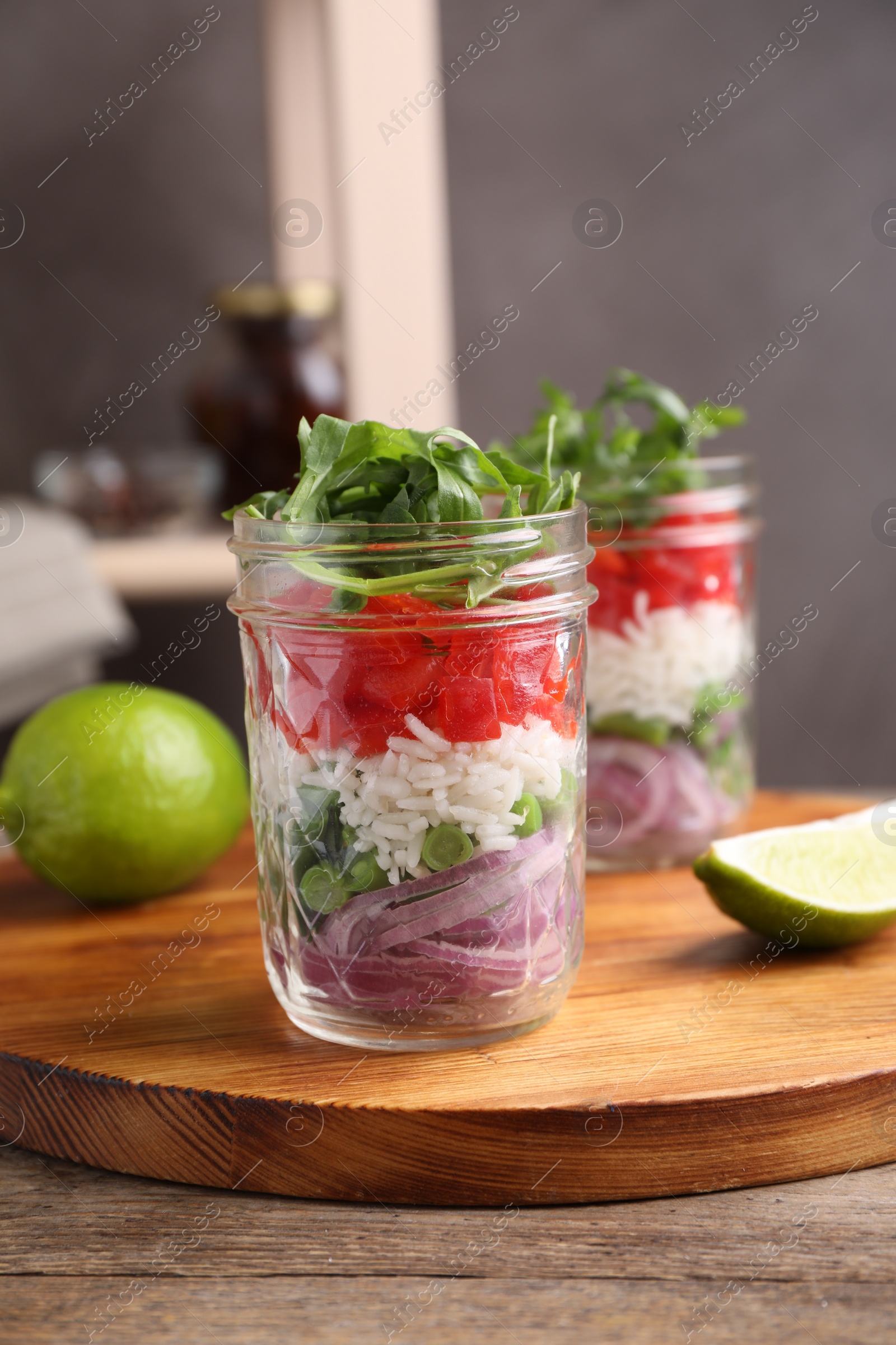 Photo of Healthy salad in glass jars on wooden table