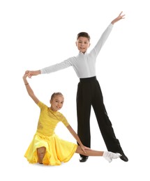 Beautifully dressed couple of kids dancing on white background