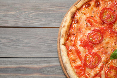 Delicious pizza Margherita on wooden table, top view. Space for text