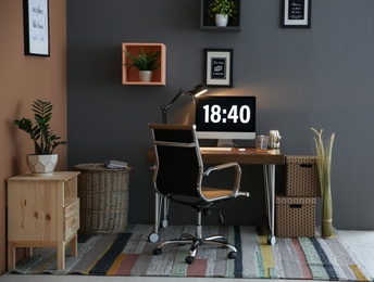 Photo of Comfortable workplace with computer on desk in home office