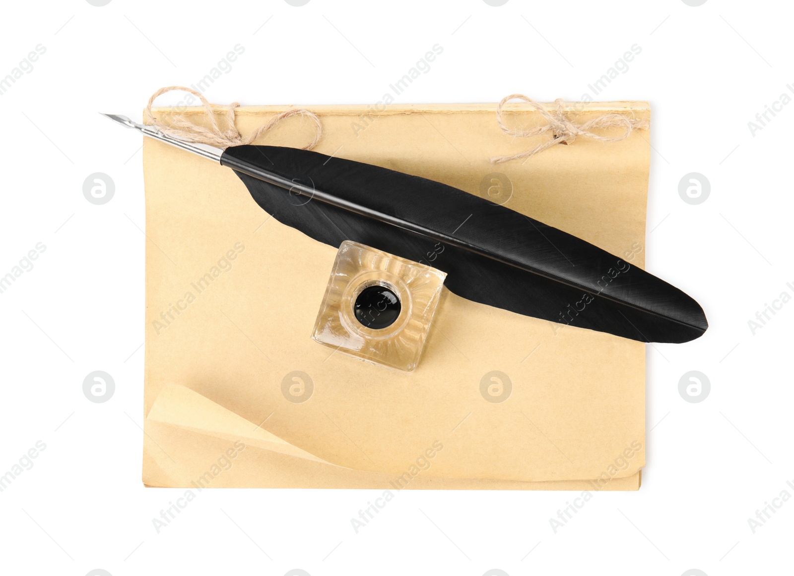 Photo of Feather pen, inkwell and old paper on white background, top view