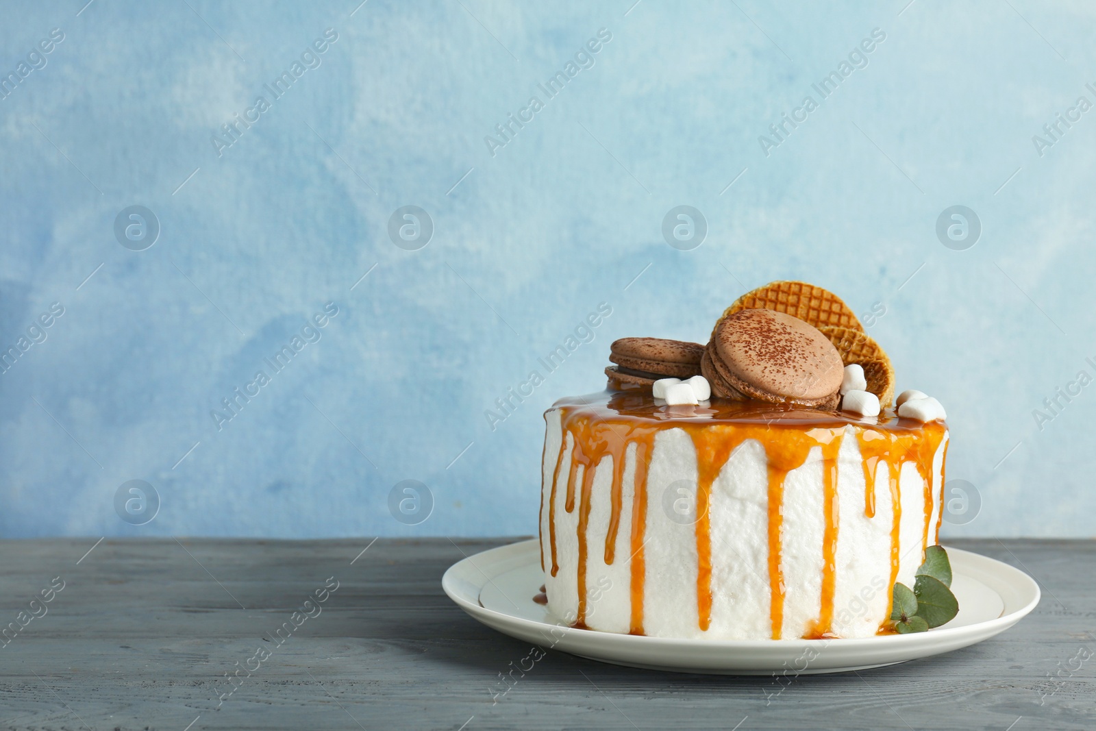 Photo of Delicious homemade cake with caramel sauce on table