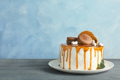 Delicious homemade cake with caramel sauce on table