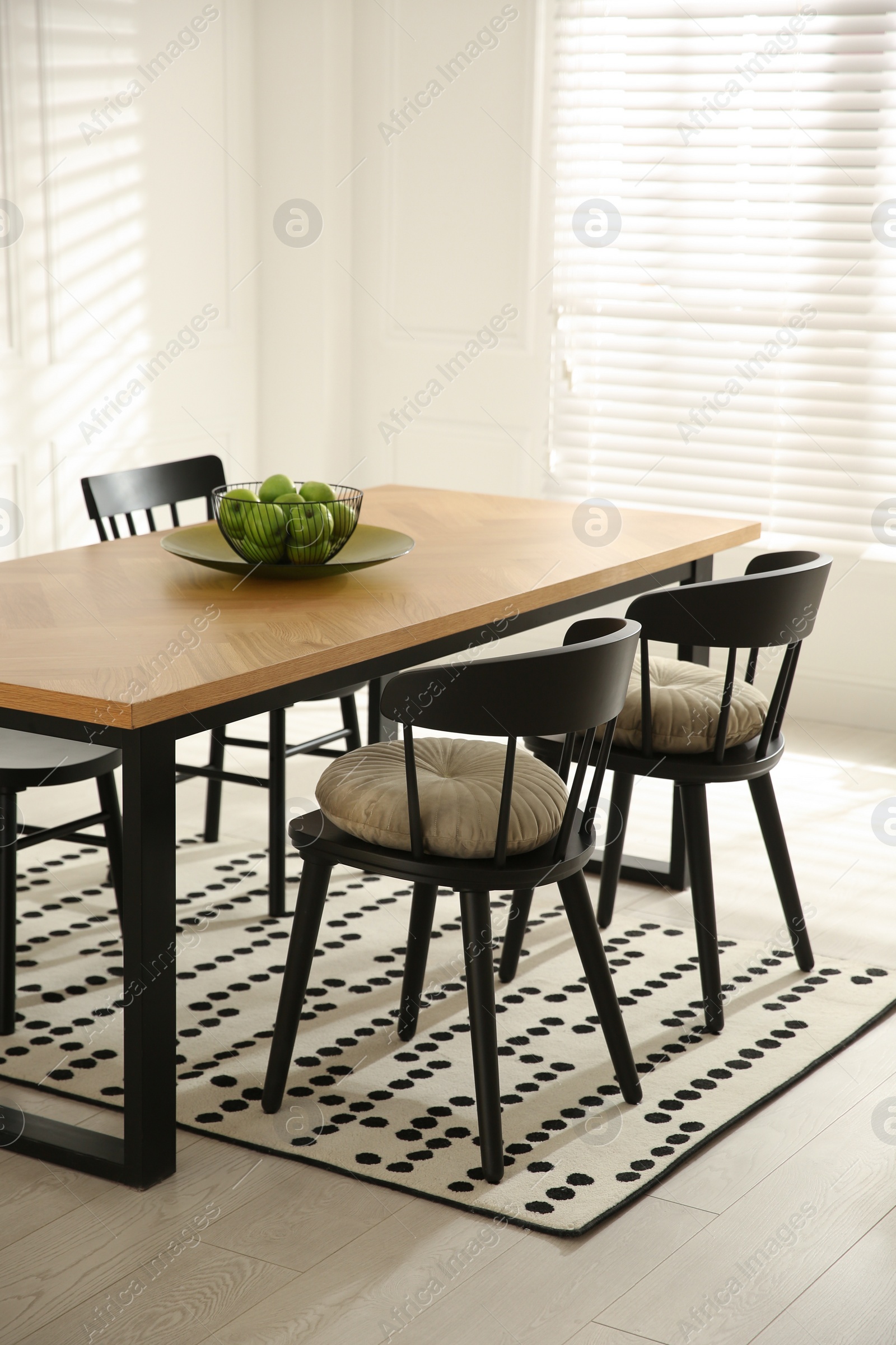 Photo of Stylish wooden dining table and chairs in room. Interior design