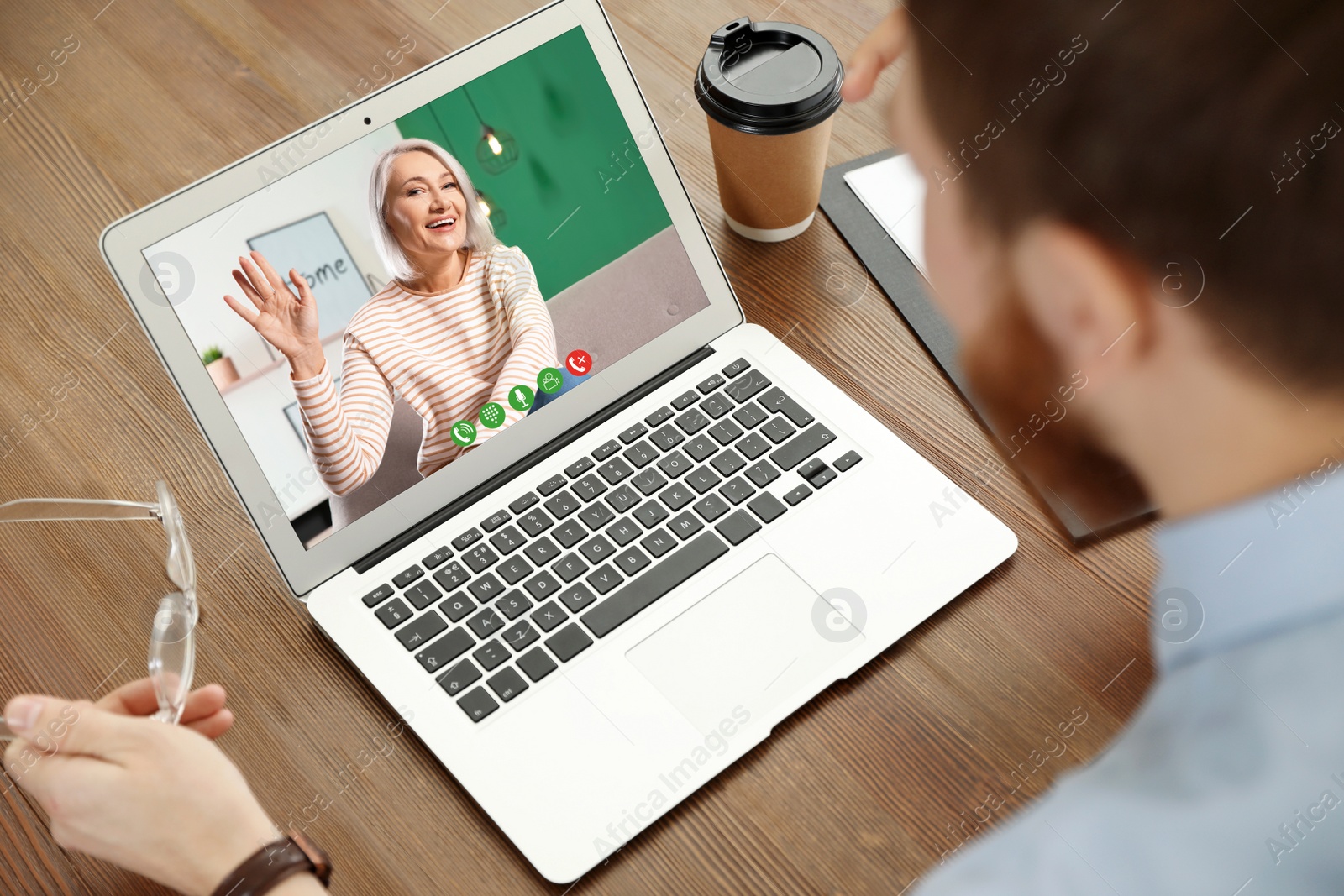 Image of Young man having video chat with his grandmother at home, focus on screen