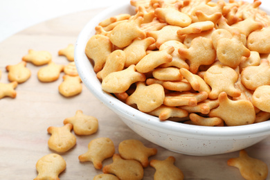 Photo of Delicious goldfish crackers in bowl, closeup view