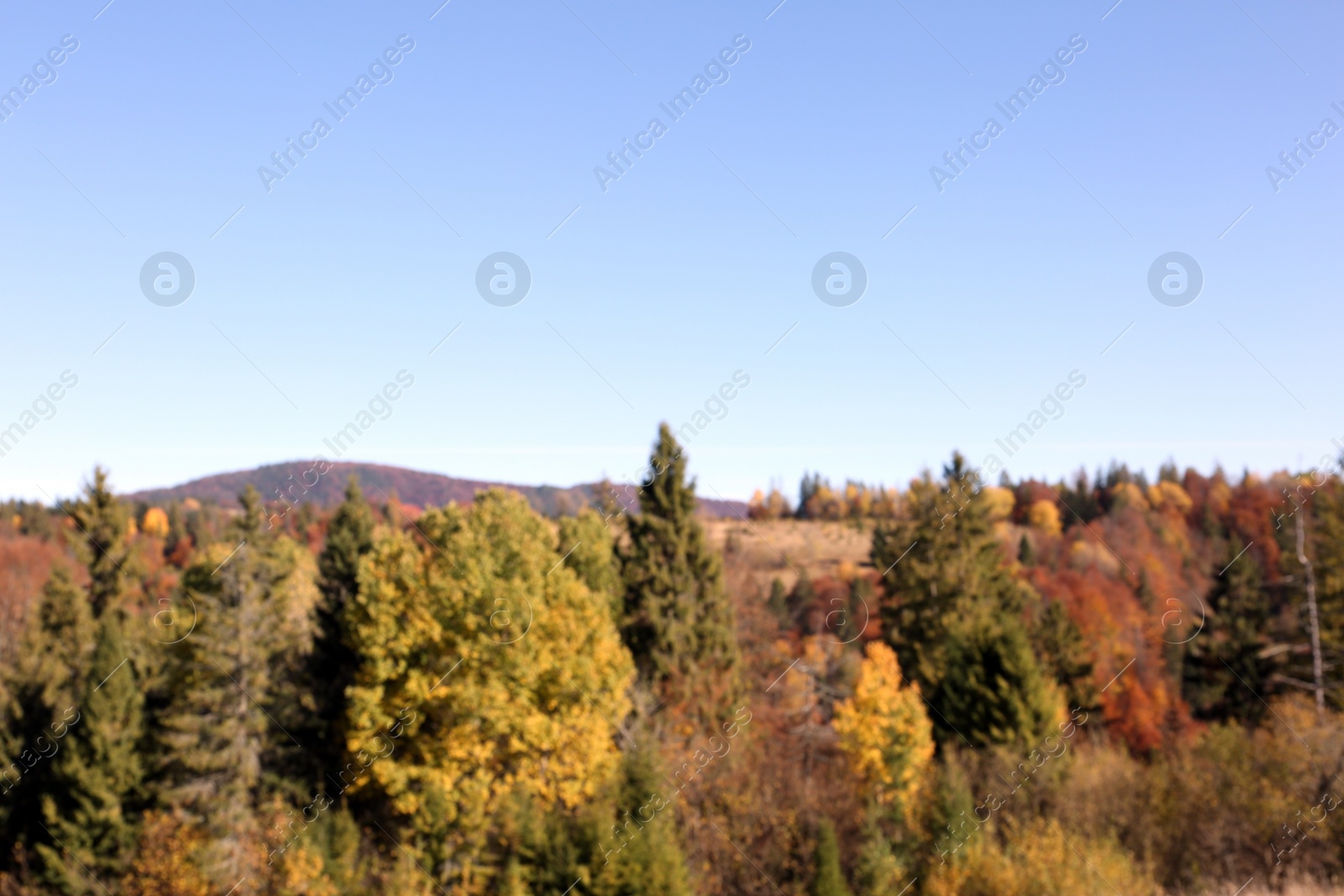 Photo of Picturesque landscape with blue sky over mountains, blurred view