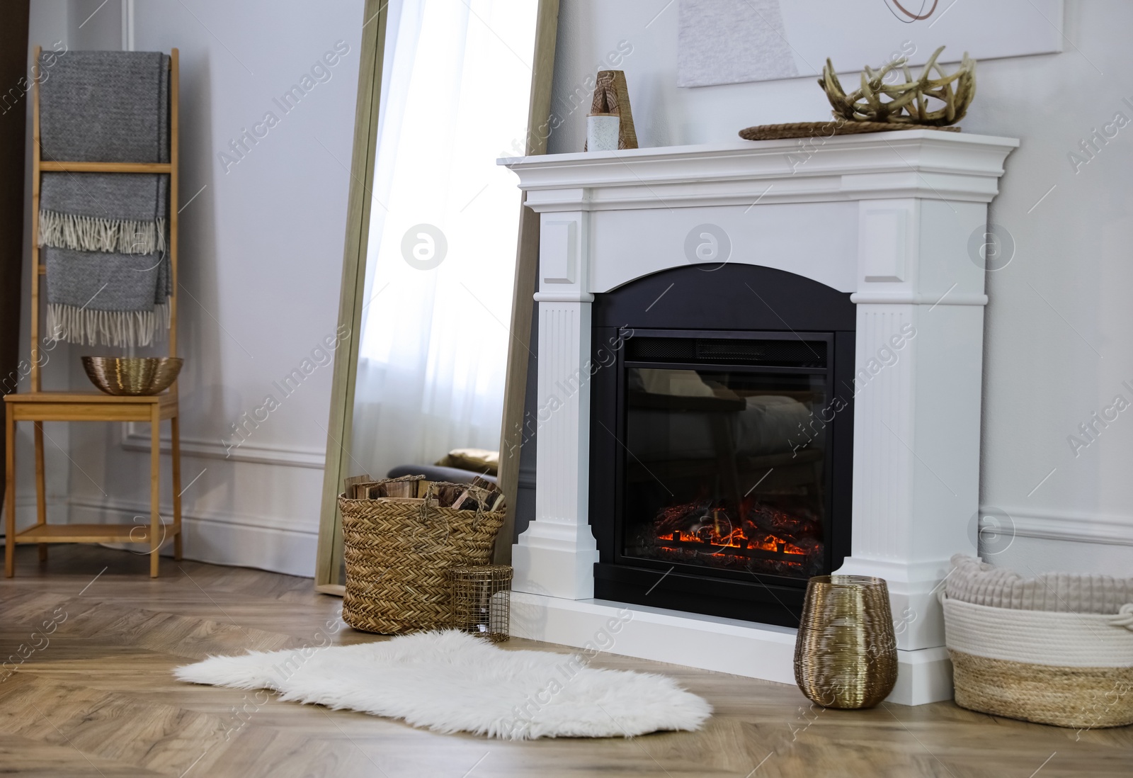 Photo of Beautiful living room interior with fireplace near white wall