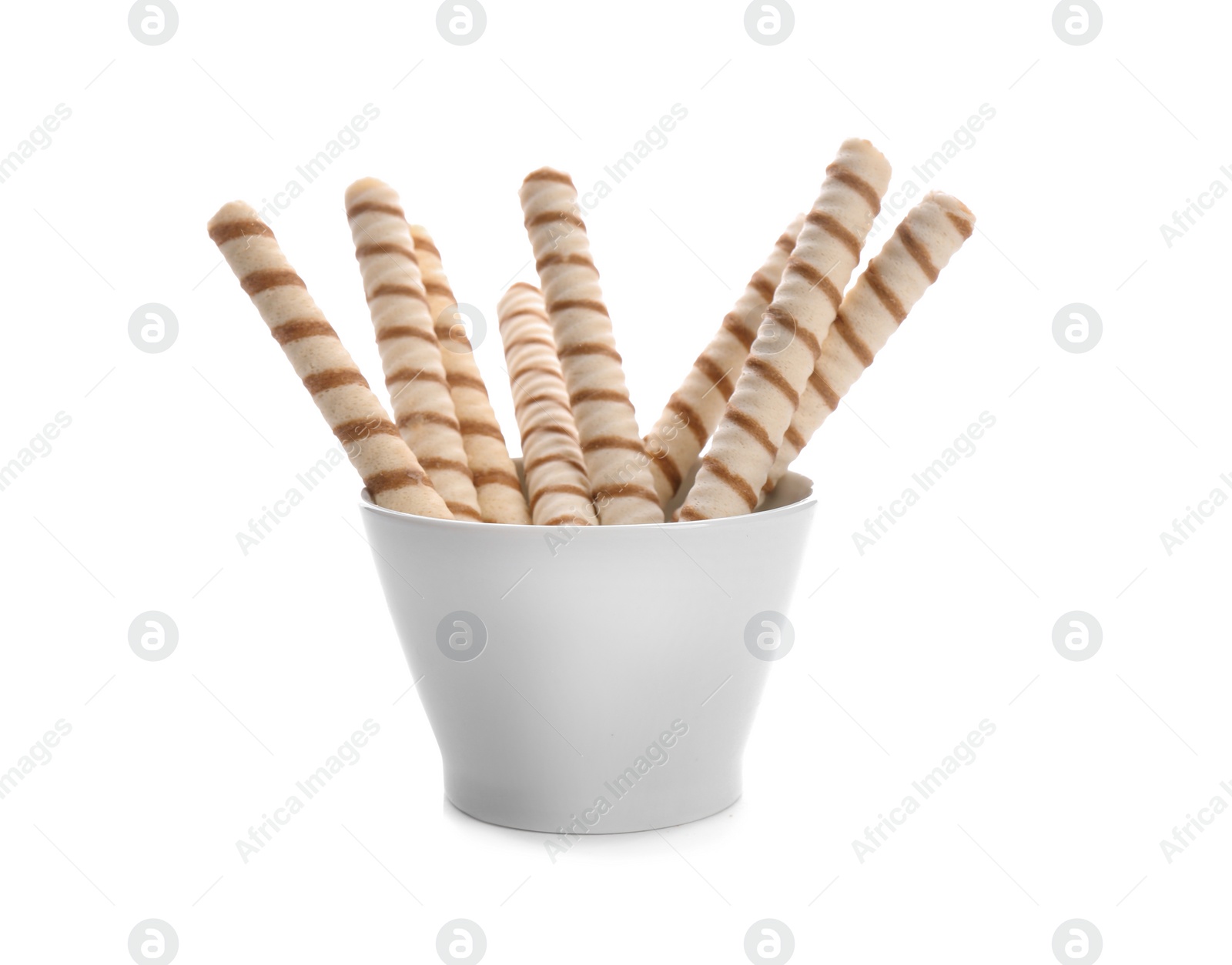 Photo of Bowl with tasty wafer roll sticks on white background. Crispy food