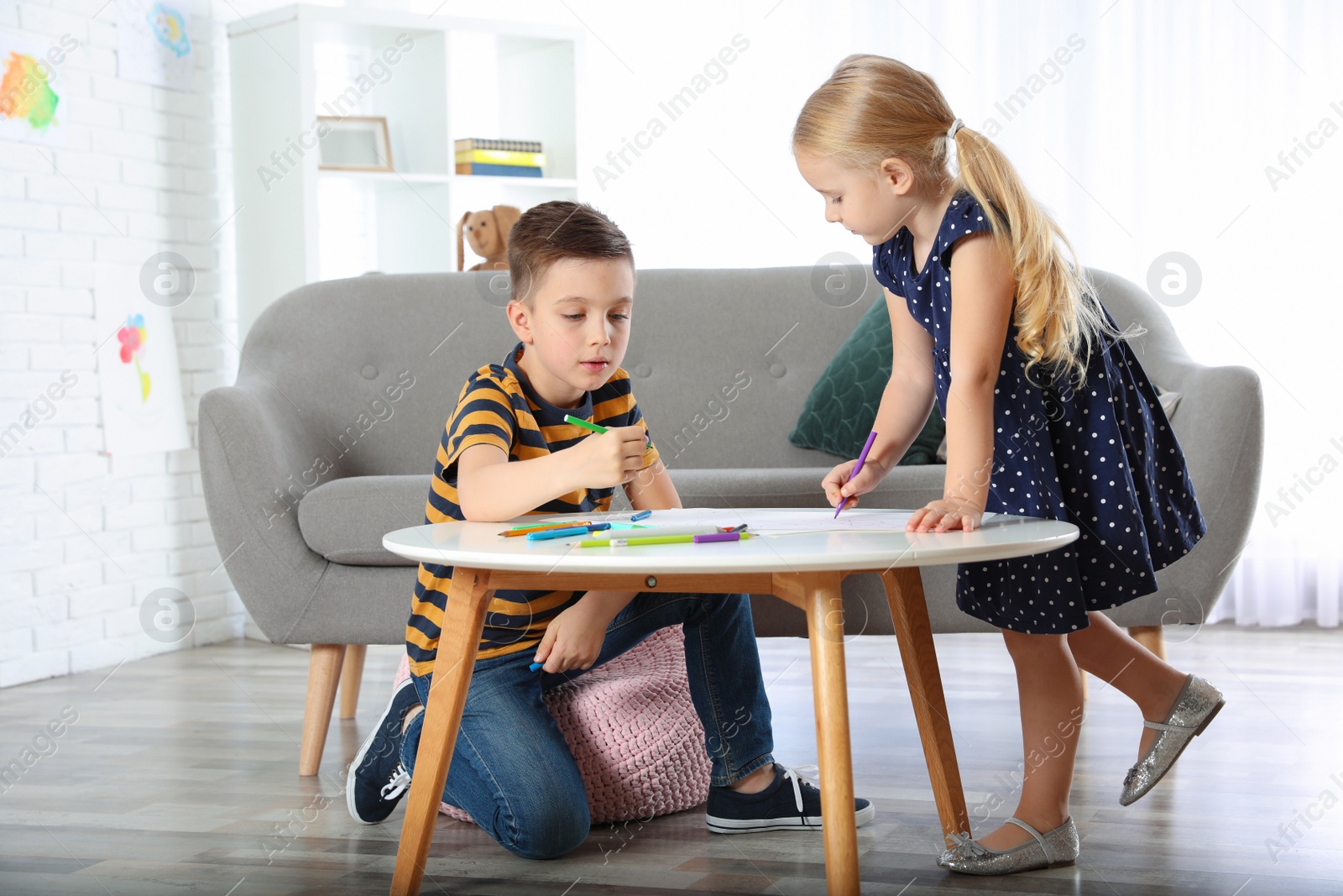 Photo of Cute little children drawing together at home