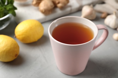 Cup of hot tea as natural cough remedy on table