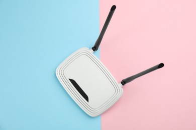 Photo of Modern Wi-Fi router on color background, top view