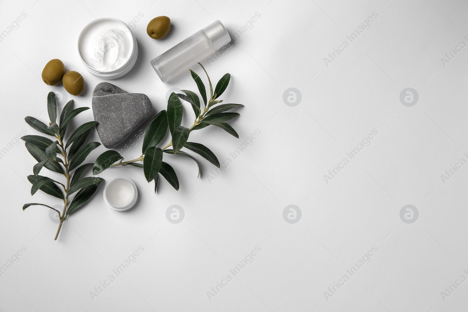 Photo of Flat lay composition with different cosmetic products and olives on white background. Space for text