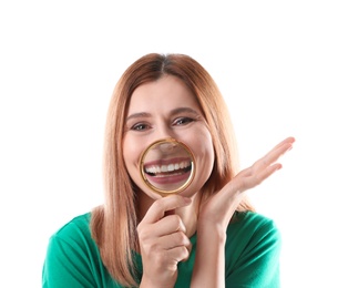 Smiling woman with perfect teeth and magnifier on white background