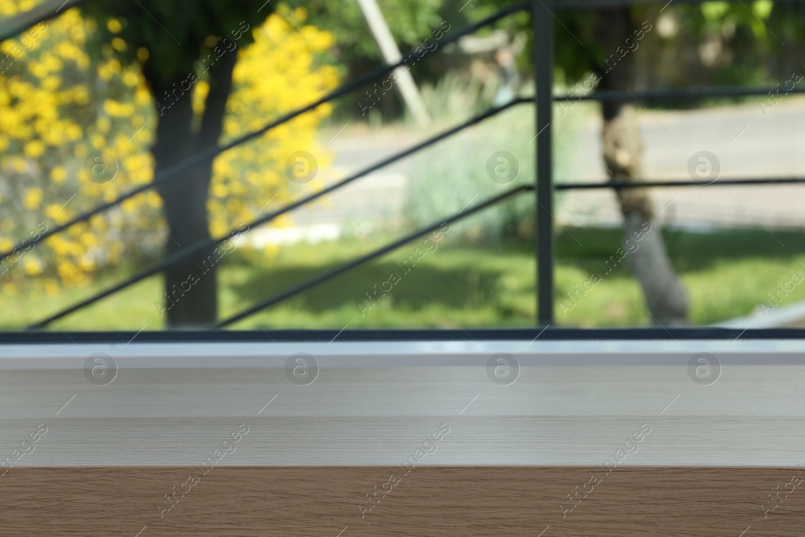 Photo of Closeup view of window with empty wooden sill