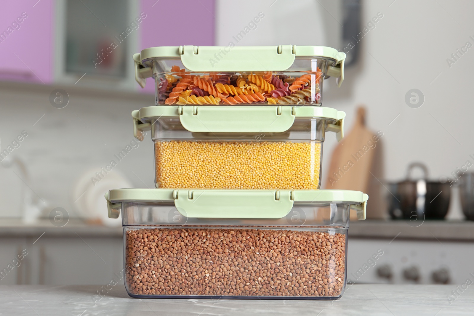 Photo of Stacked boxes with different food on table in kitchen