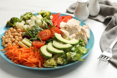 Balanced diet and healthy foods. Plate with different delicious products on white marble table