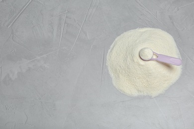 Pile of protein powder, scoop and space for text on grey background, above view. Preparing shake