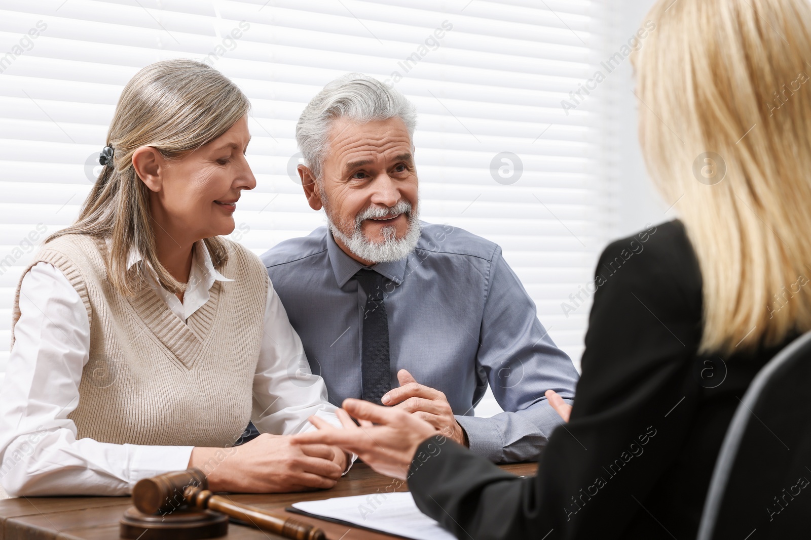 Photo of Senior couple having meeting with lawyer in office