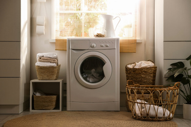 Photo of Stylish room interior with washing machine. Design idea