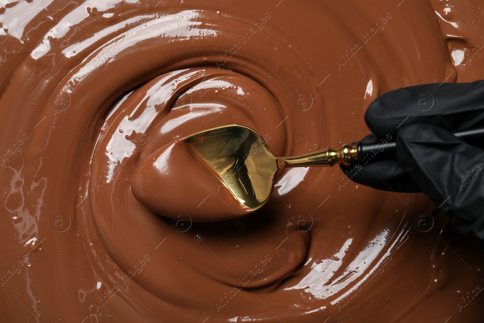 Photo of Person making tasty milk chocolate paste, top view