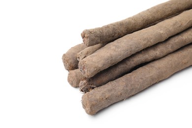 Photo of Fresh raw salsify roots on white background, above view. Space for text