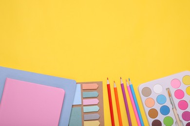 Flat lay composition with different school stationery on yellow background, space for text. Back to school