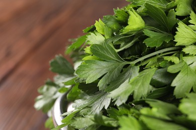 Photo of Fresh green parsley leaves on table, closeup