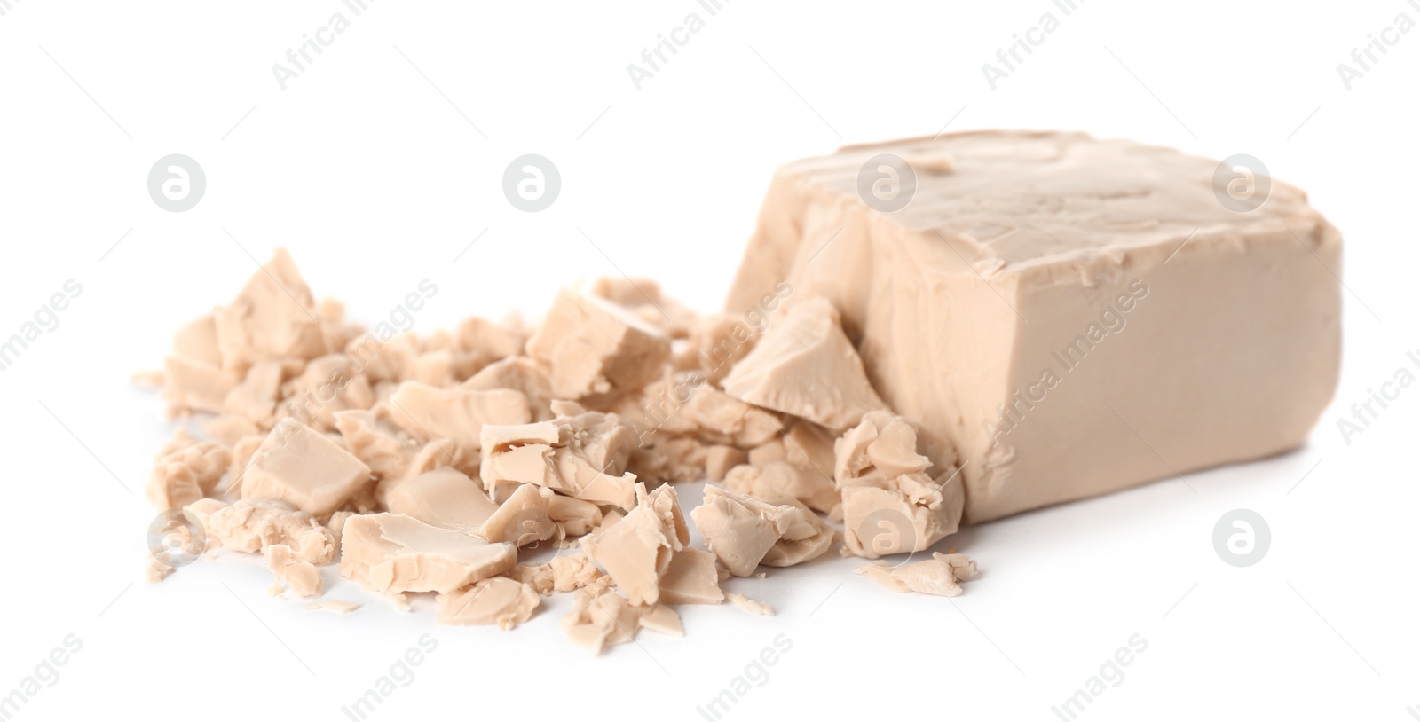 Photo of Crumbled block of compressed yeast on white background
