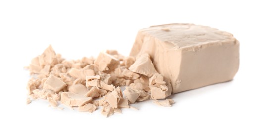 Photo of Crumbled block of compressed yeast on white background