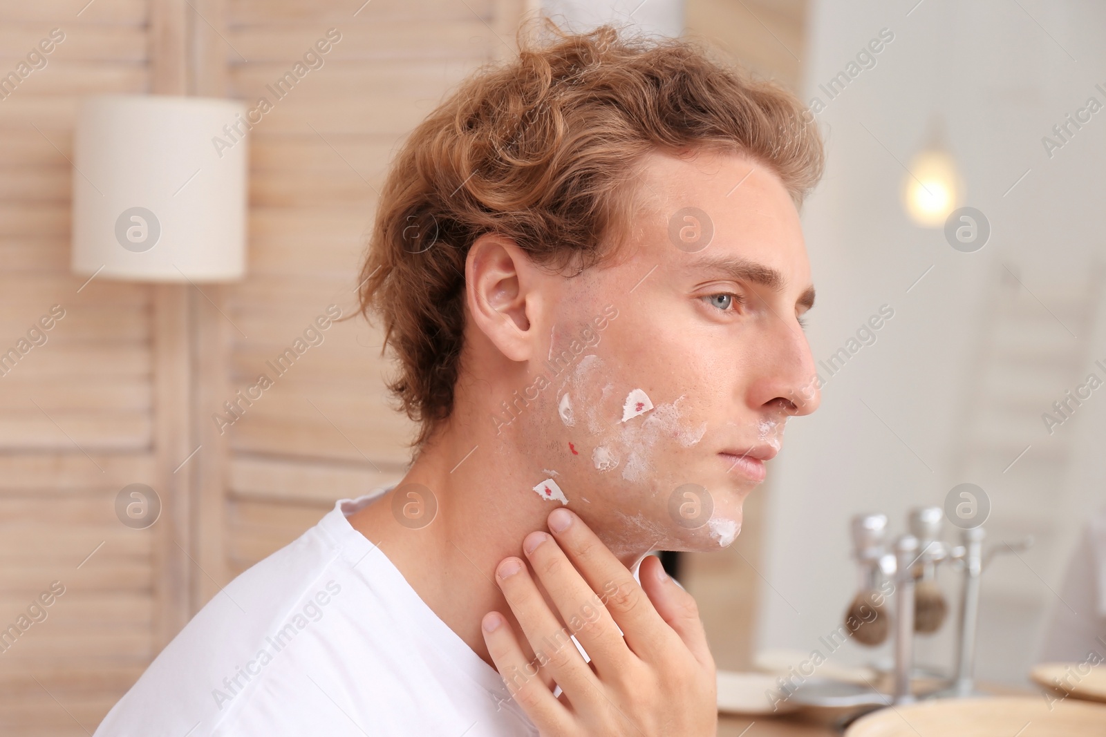 Photo of Young man with face hurt while shaving at home