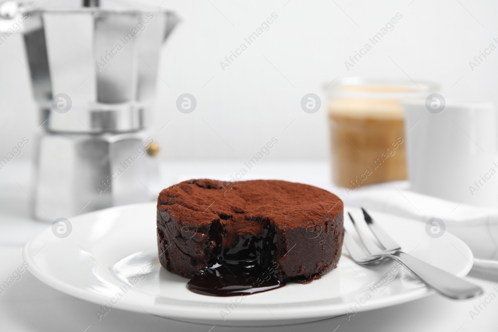 Photo of Delicious fresh fondant with hot chocolate served on white table