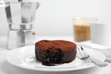 Photo of Delicious fresh fondant with hot chocolate served on white table