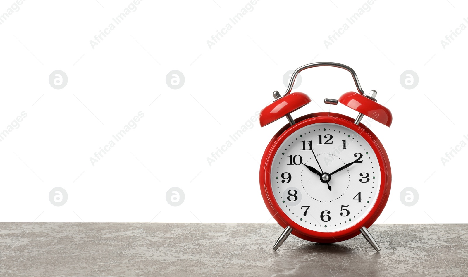 Photo of Alarm clock on table against white background. Time concept