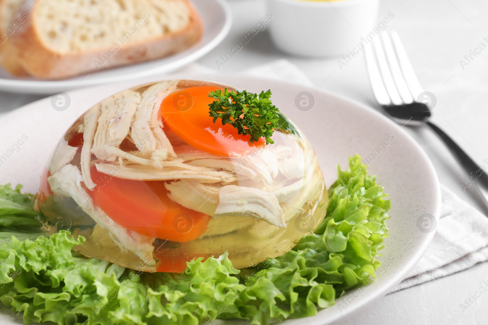 Photo of Delicious chicken aspic with vegetables on plate, closeup