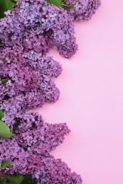 Photo of Beautiful lilac flowers on pale pink background, top view. Space for text