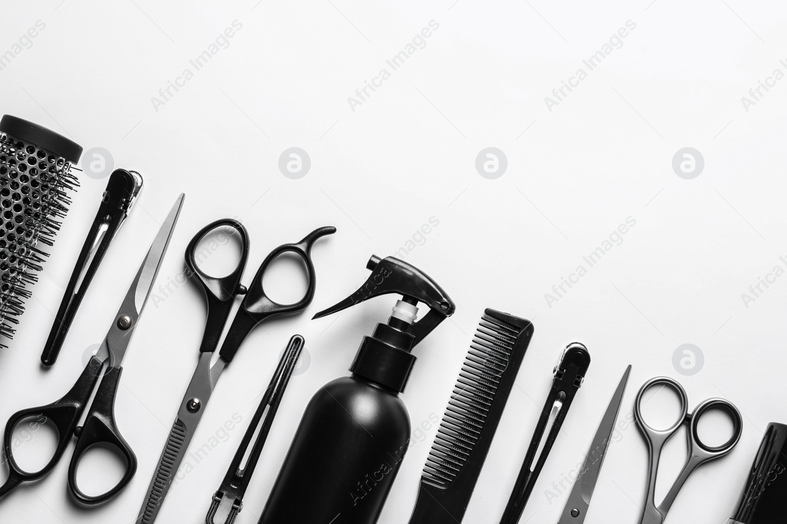 Photo of Composition with scissors and other hairdresser's accessories on white background, top view