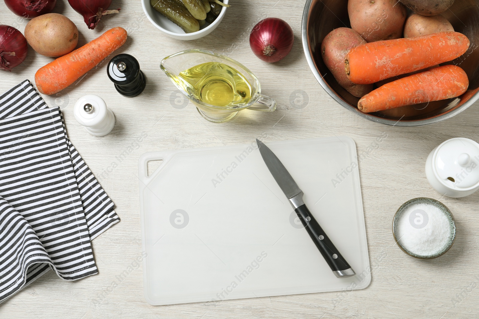 Photo of Many fresh vegetables and other ingredients on white wooden table, flat lay. Cooking vinaigrette salad