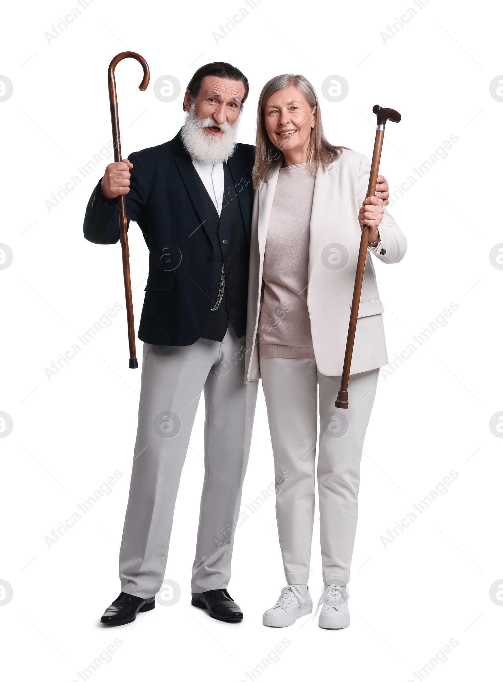 Photo of Senior man and woman with walking canes on white background