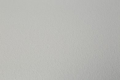 Photo of Blank white canvas as background, closeup view