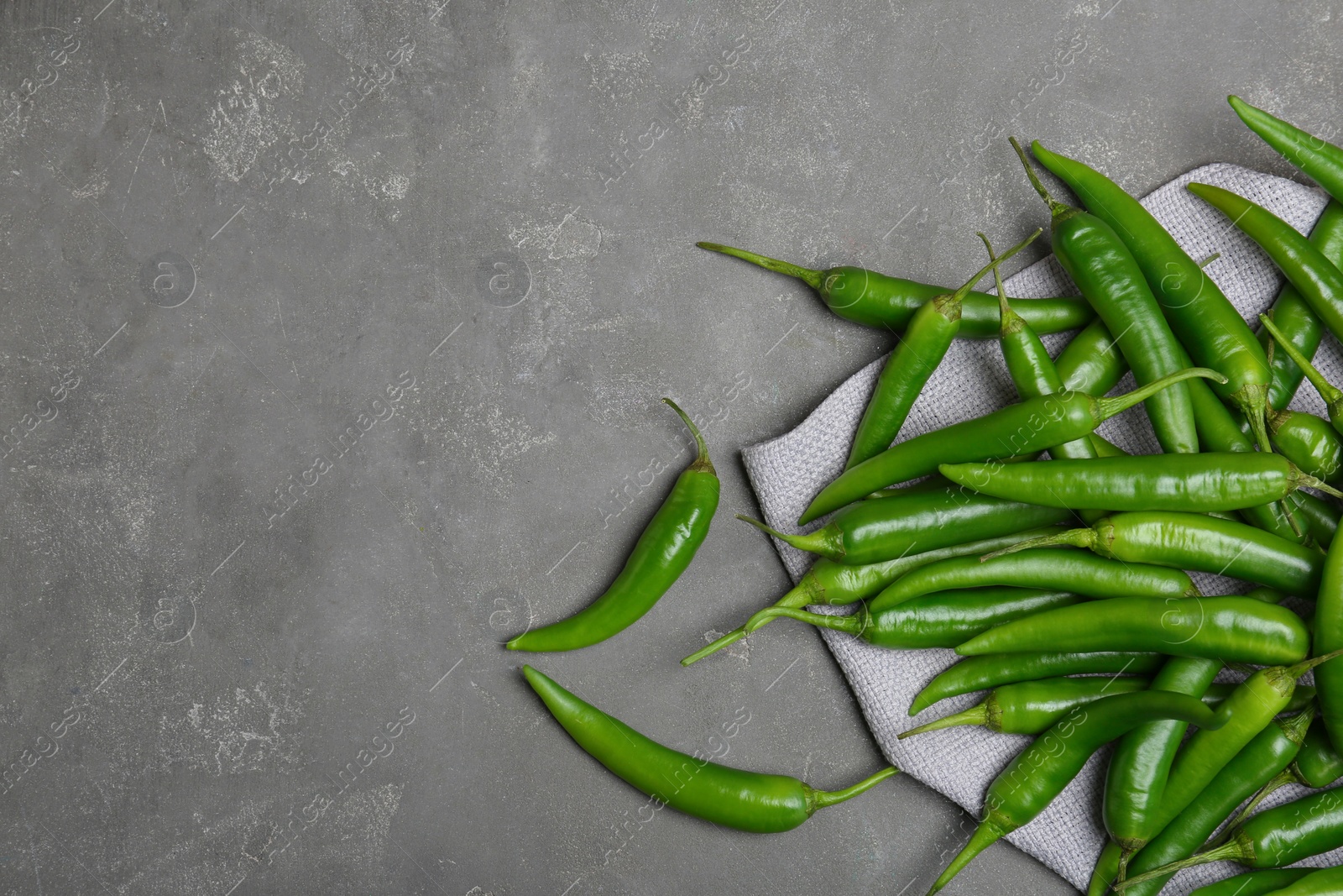 Photo of Flat lay composition with chili peppers on grey background