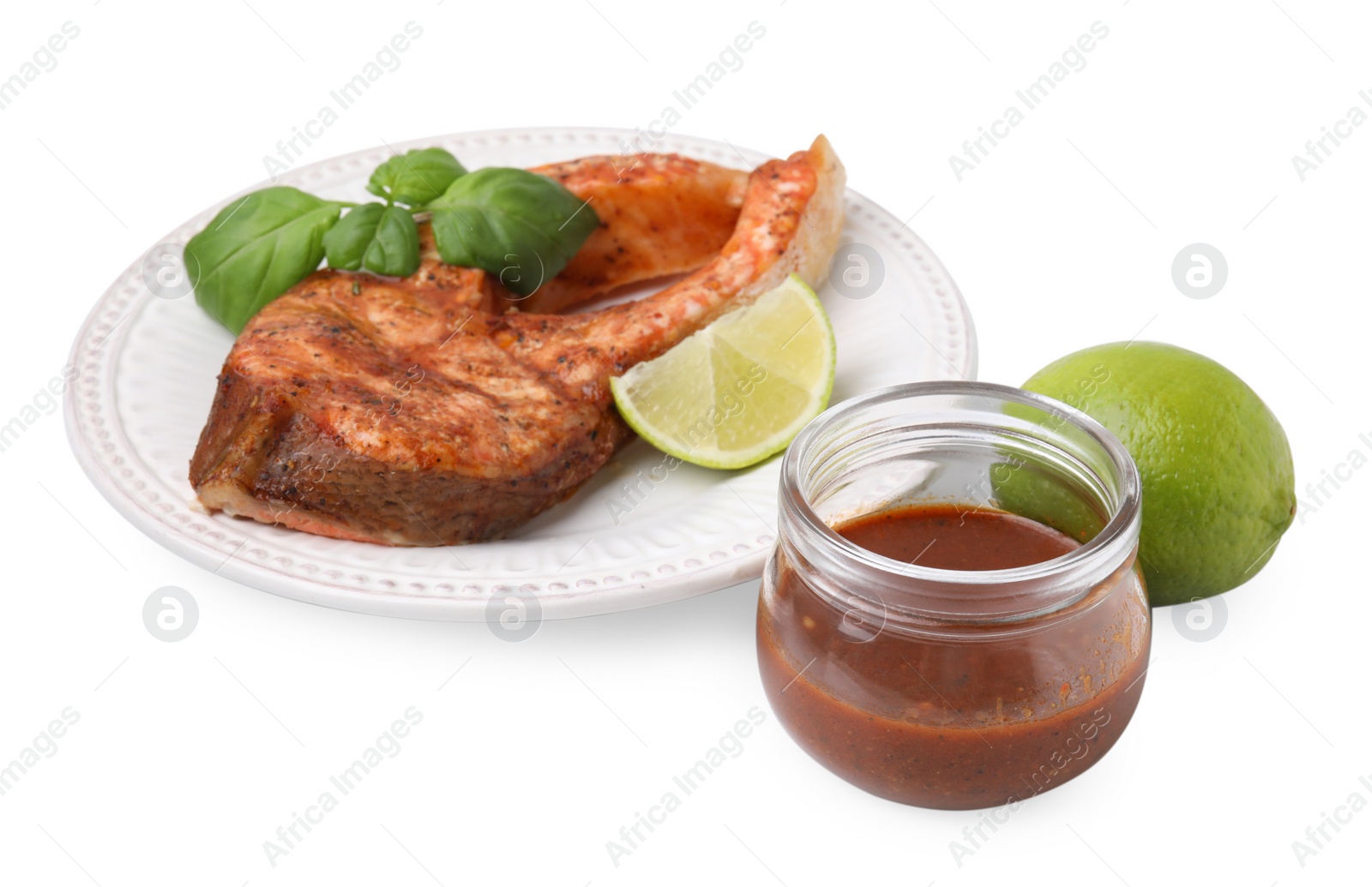 Photo of Fresh marinade, cooked fish, lime and basil isolated on white