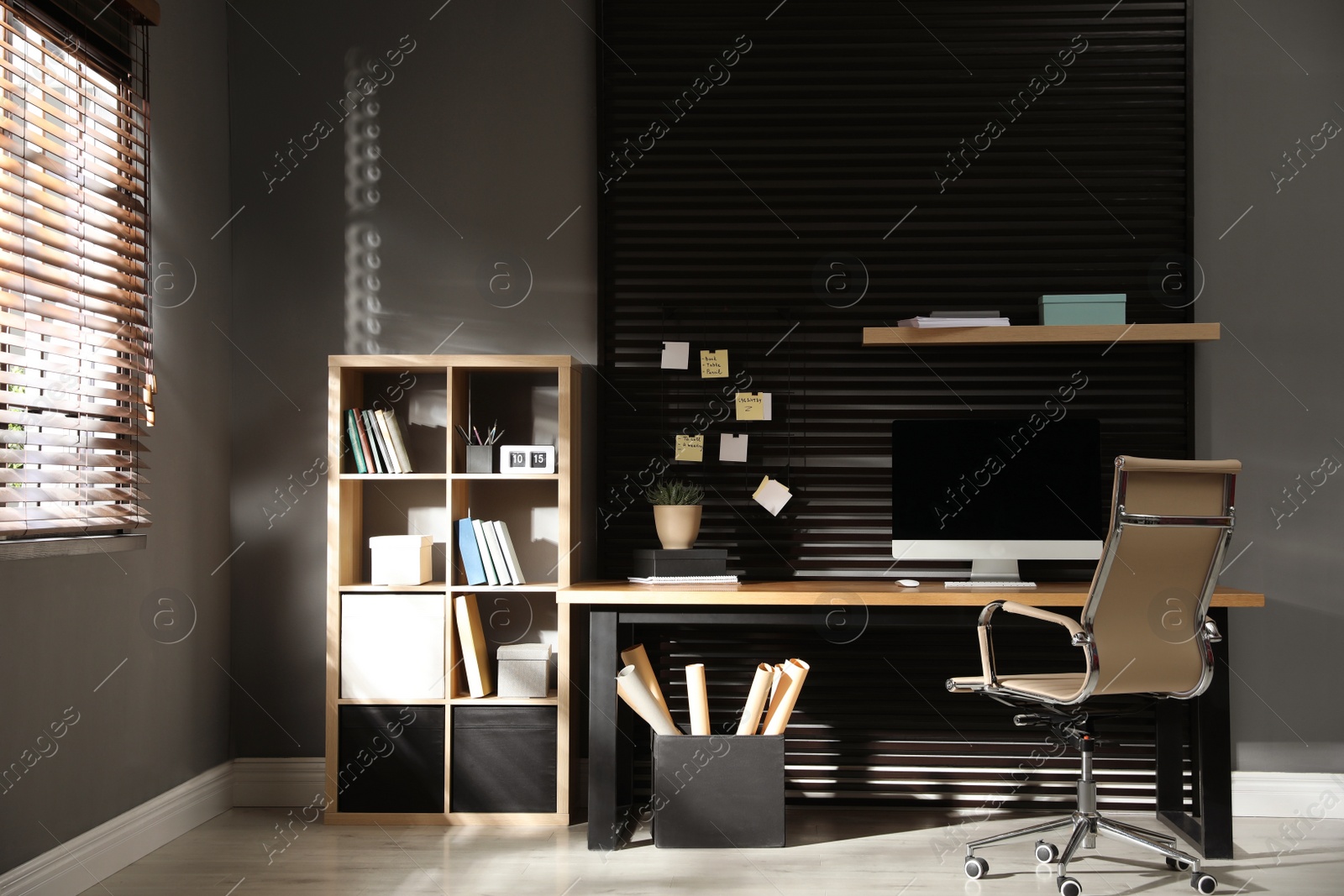 Photo of Comfortable workplace with computer and office chair. Stylish room interior