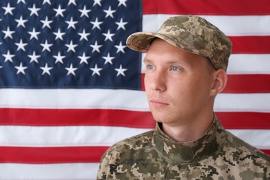 Photo of Soldier in uniform against United states of America flag