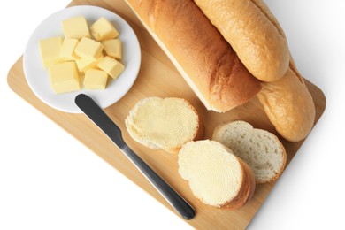 Photo of Whole and cut baguettes with fresh butter on white background, top view