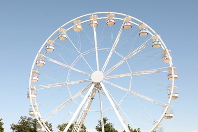 Beautiful white ferris wheel against blue sky