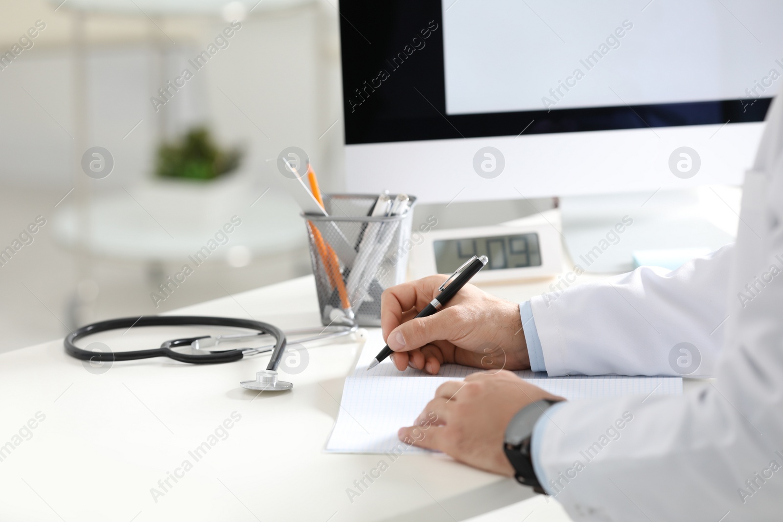 Photo of Doctor working at desk in office, closeup